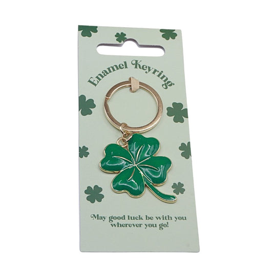 Green four-leaf clover keychain on a green card with shamrock designs