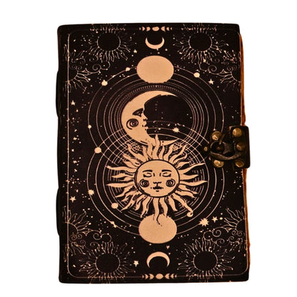 leather bound book with an image of a sun and moon on the front