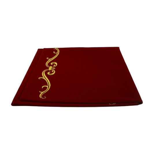Red cloth with gold decorative elements on a white background 