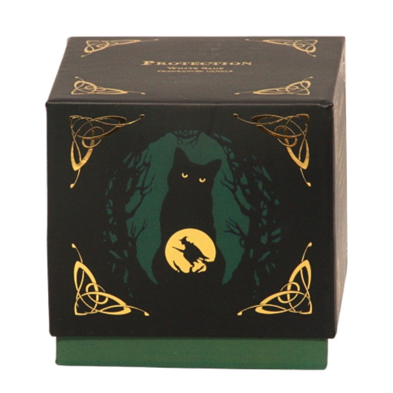 candle gift box-black with green and gold- featuring a black cat and witch flying on a broomstick- on front with the word "protection" written in gold on top.