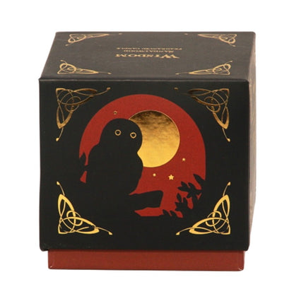 Candle gift box in black with a  red and gold owl on front with the word "wisdom" written in gold on top