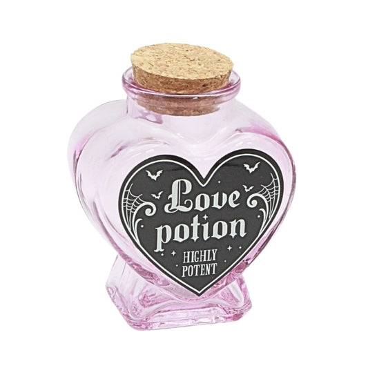 Heart-shaped pink glass jar with cork lid labeled 'Love potion Highly Potent' on a white background