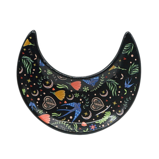 Decorative black crescent moon-shaped plate with colorful patterns on a white background