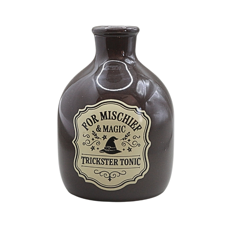 dark coloured ceramic bottle with a tapered neck and old style vintage label that reads "for mischief and magic trickster tonic"