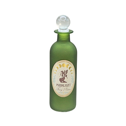 An olive green glass bottle with a white and beige oval label reading 'MOONLIGHT Fairy Potion' and a small fairy illustration, on a white background.