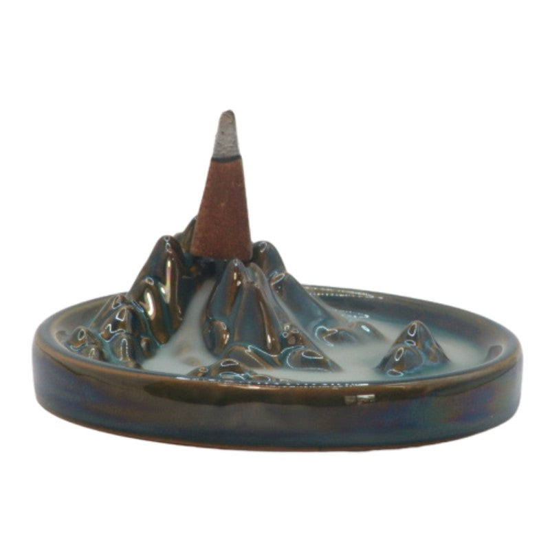 Incense cone on a green ceramic mountain incense burner