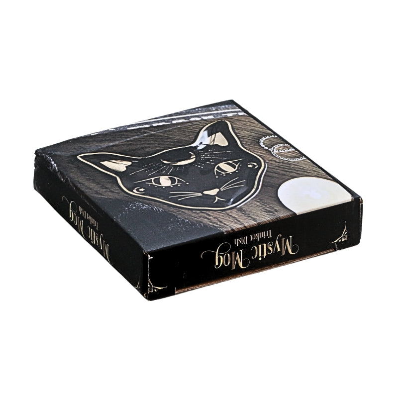 A square black product box with a stylized cat face illustration and gold decorative text reading 'Mystic Mog' on a plain white background.
