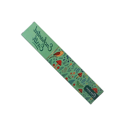 green incense box with mushroom forest design and an owl with the words "enchanted earth", on a white background.