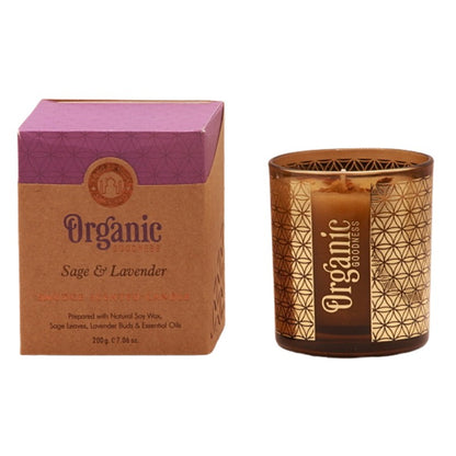 organic goodness candle box next to soy candle in a brown and gold votive candle jar