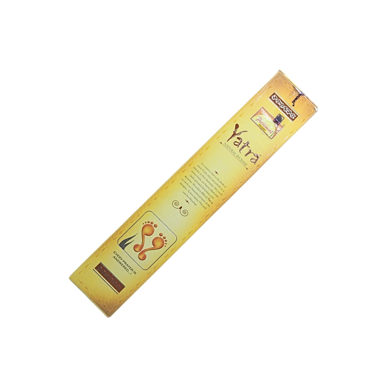 Front view of the gold Parimal Yatra 15g incense box with brown lettering and a footprint design.
