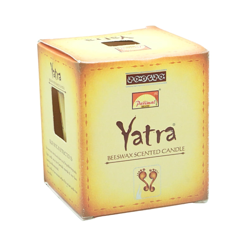 Front view of the gold Parimal Yatra beeswax candle box with brown lettering and a footprint design
