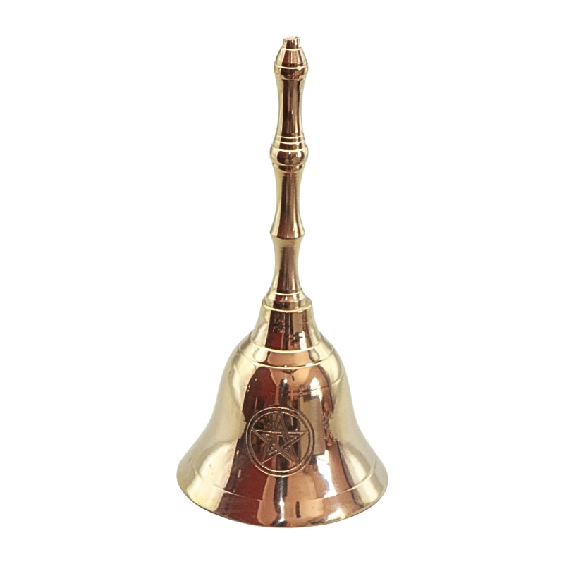 A polished brass bell with a decorative handle, featuring an engraved pentacle symbol on the front, set against a plain white background.