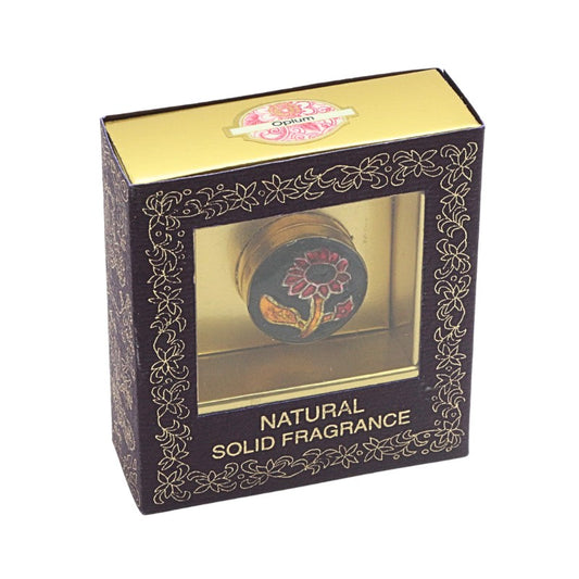 Solid perfume oil in floral design box on white background