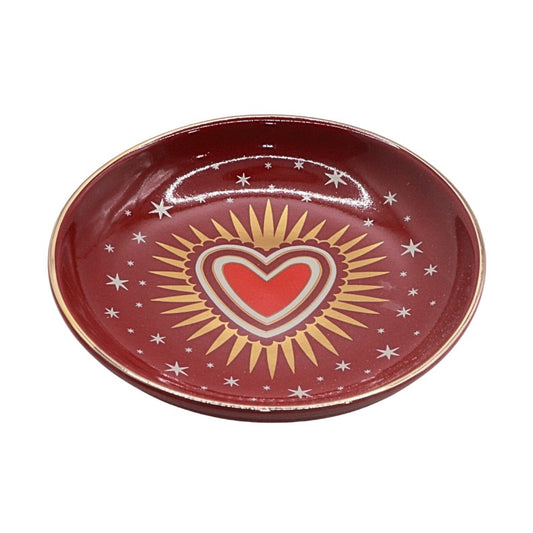 Red ceramic plate with a heart design on a white background