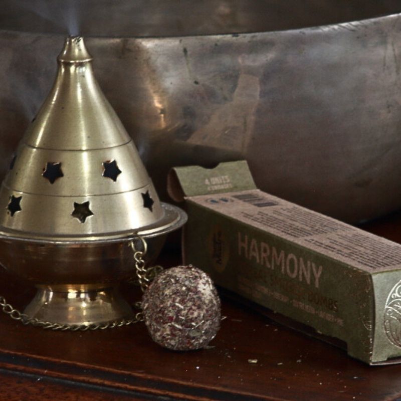 packet of Sagrada Madre smudge bombs next to brass thurible