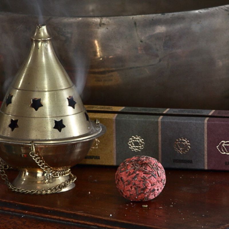 packet of Sagrada Madre smudge bombs next to brass thurible