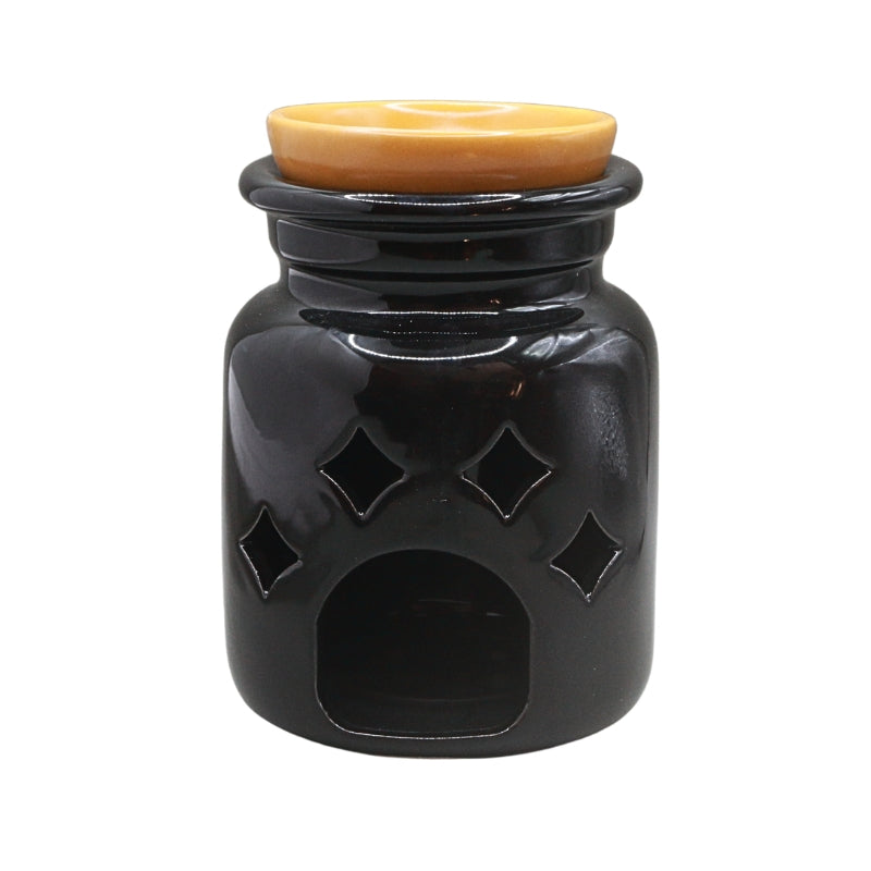 A glossy black ceramic oil warmer with diamond-shaped cutouts and a warm amber-colored lid, shown against a plain white background.