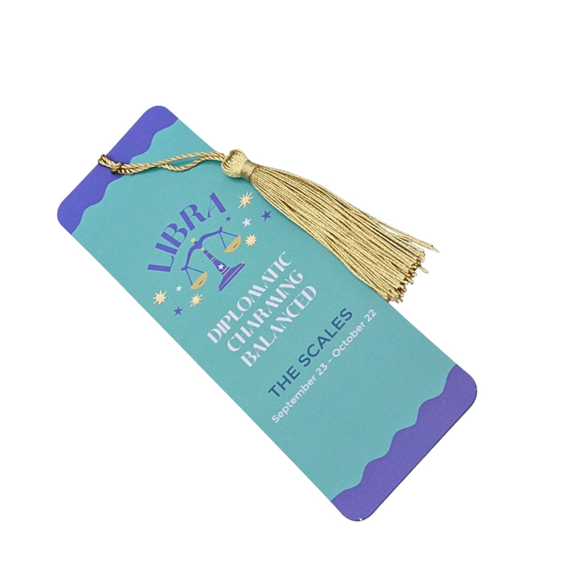 green and purple bookmark with gold tassel and white and purple writing, on a white background