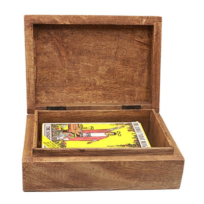 An open rectangular wooden box with a hinged lid, shown on a plain white background. Inside the box is a tarot card deck, with the 'Magician' card visible on the bottom shelf.