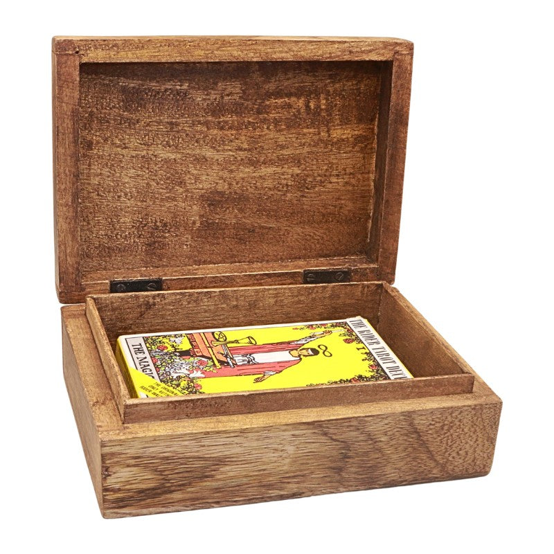 An open wooden box with a rustic brown finish, containing a tarot card deck with a yellow 'The Magician' card visible inside.