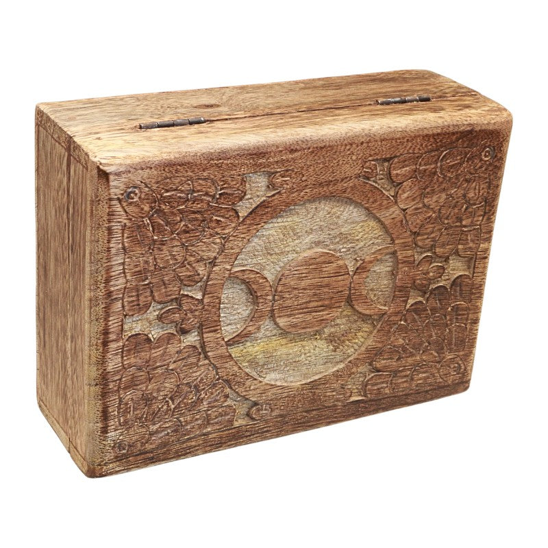 A rectangular wooden box with a slot on top, featuring hand-carved floral and circular motifs on the front, shown against a plain white background.