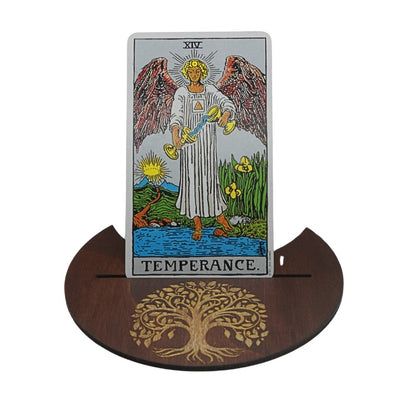 Tarot card titled 'Temperance' on a wooden stand with a tree design.