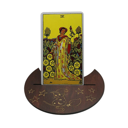 Tarot card with a woman and birds on a wooden stand with star designs.