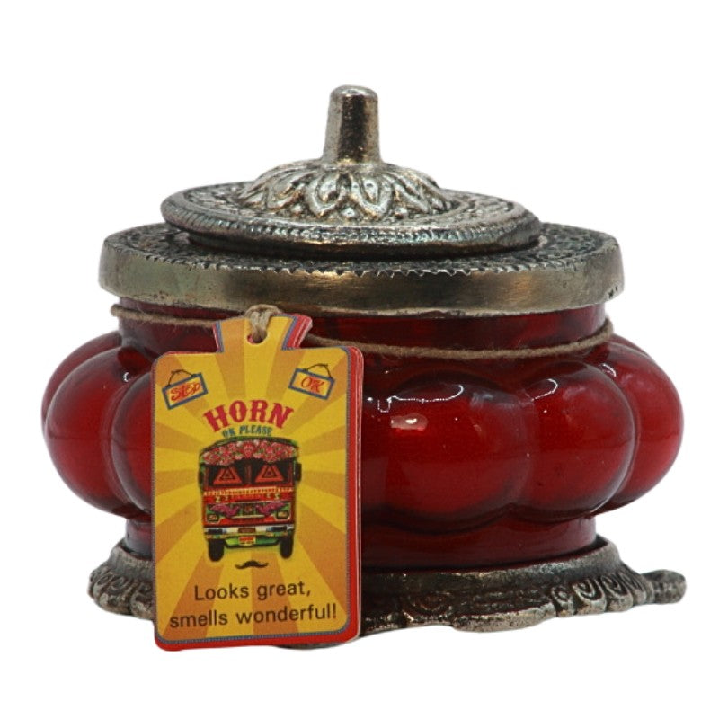 red ornate glass candle jar with a metal lid