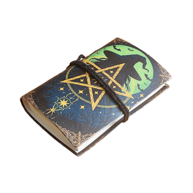 small notebook with brown tie and image of a witches hat and pentacle in front of a moon, on  a white background