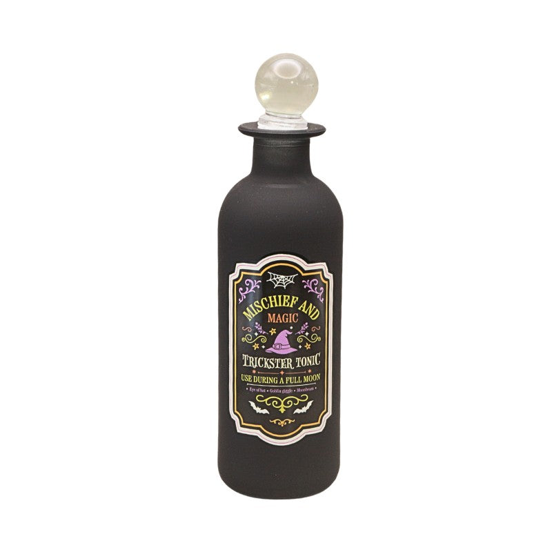 decorative black bottle with round glass stopper and a green and purple spooky design label with witches hat design
