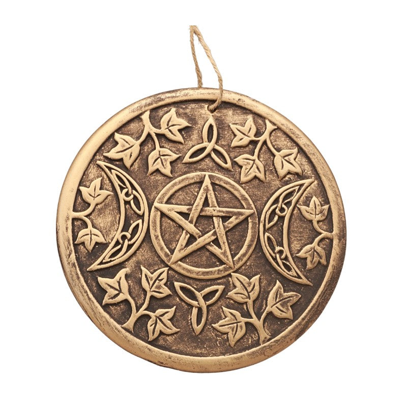 round gold plaque with a triple moon and floral design