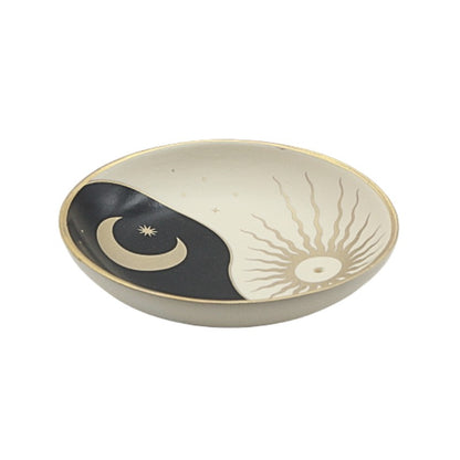 Ceramic incense holder with yin yang design on a white background