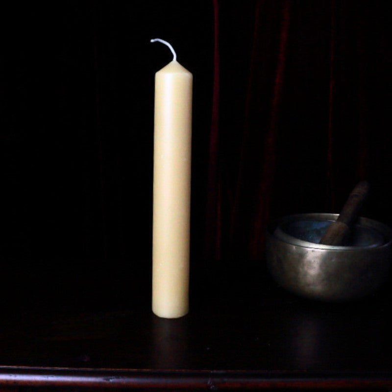 40 x 250mm beeswax pillar candle on wooden apothecary cabinet next to singing bowl