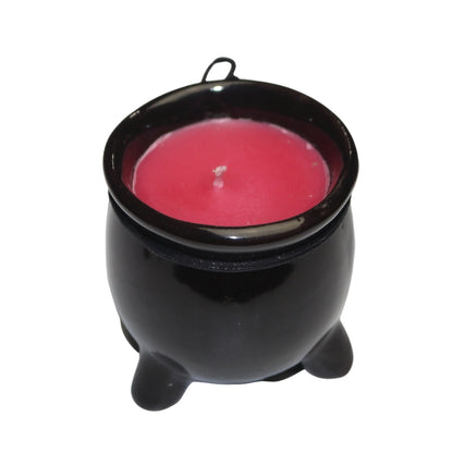 Red wax candle in a black ceramic cauldron