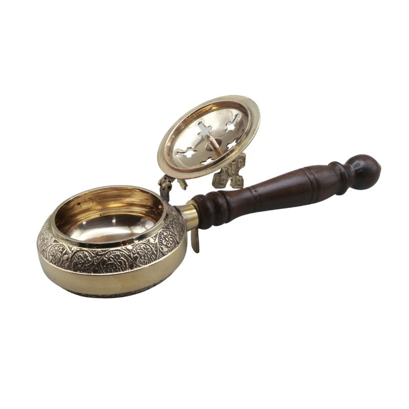 Brass charcoal burner with wooden handle on a white background