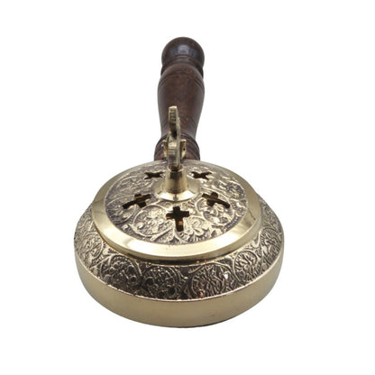Decorative brass incense burner with intricate designs on a white background