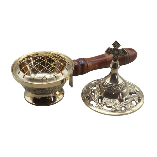 Brass incense burner with wooden handle and decorative base on a white background