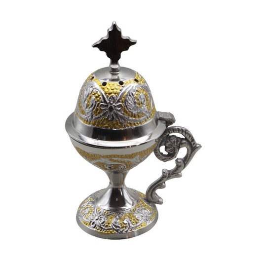Decorative metal incense burner with intricate designs on a white background