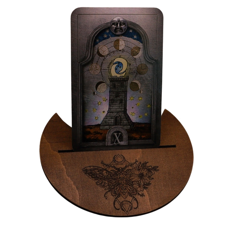 handmade tarot card holder with death moth design, holding a nostradamus tarot card