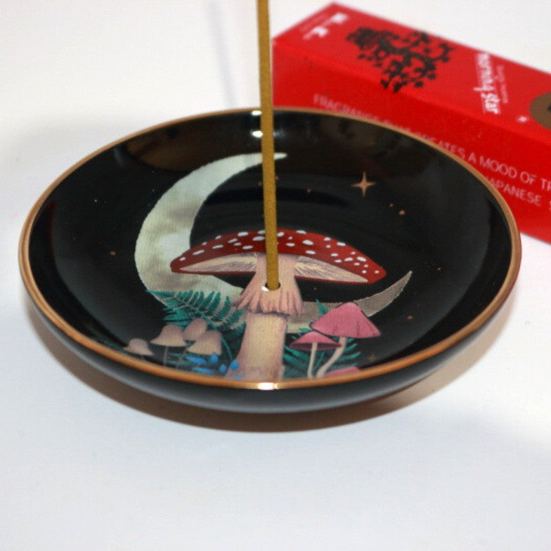 mushroom forest design incense dish in front of a box of japanese incense