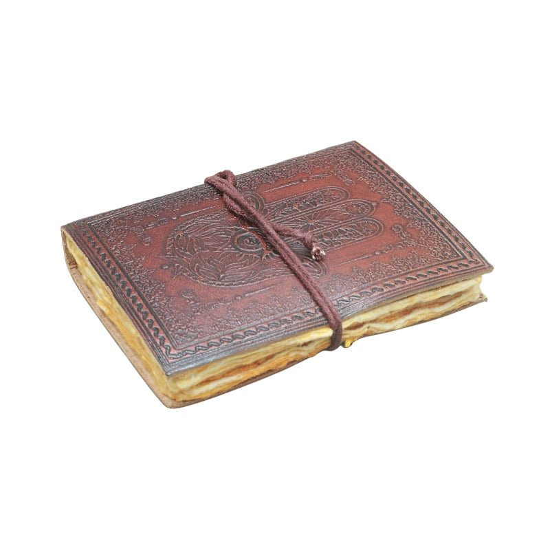brown leather journal, embossed with image of a hand, with a brown tie, on a white background