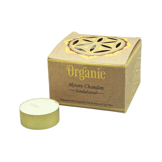 tealight candle in front of a cardboard packaging box of canles