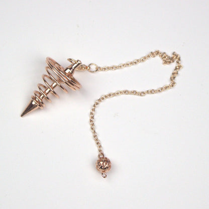 rose gold spiral pendulum on white background