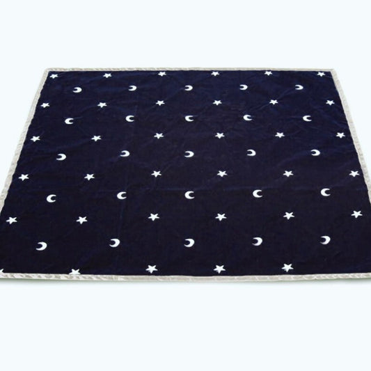 blue velvet tarot cloth with white crescent moon and star shapes embroidered on it- silver ribbon border