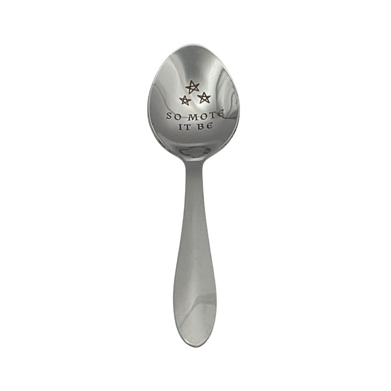 Silver spoon with engraved text 'SO-MOTE IT BE' on a white background