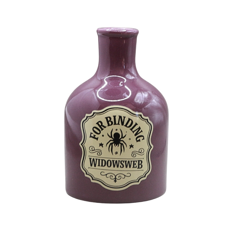 A small glossy purple bottle with a cream label reading 'FOR BINDING WIDOWSWEB' and featuring a spider graphic, isolated on a white background.