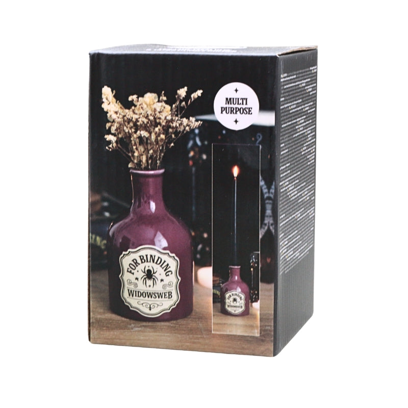 A boxed product labeled 'For Binding: Widowsweb' in a dark purple bottle-shaped container, shown in its retail packaging with a 'Multi Purpose' badge. The box front features a photo of dried flowers in the bottle and a small inset showing a lit candle in the top of the container