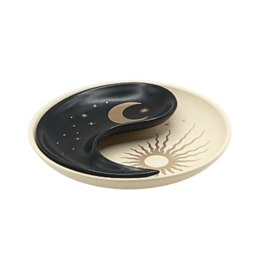 Decorative plate with sun and moon design on a white background